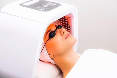 Patient undergoing LED light therapy treatment in a professional aesthetic clinic.